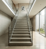 Wide, straight staircase with a glass railing